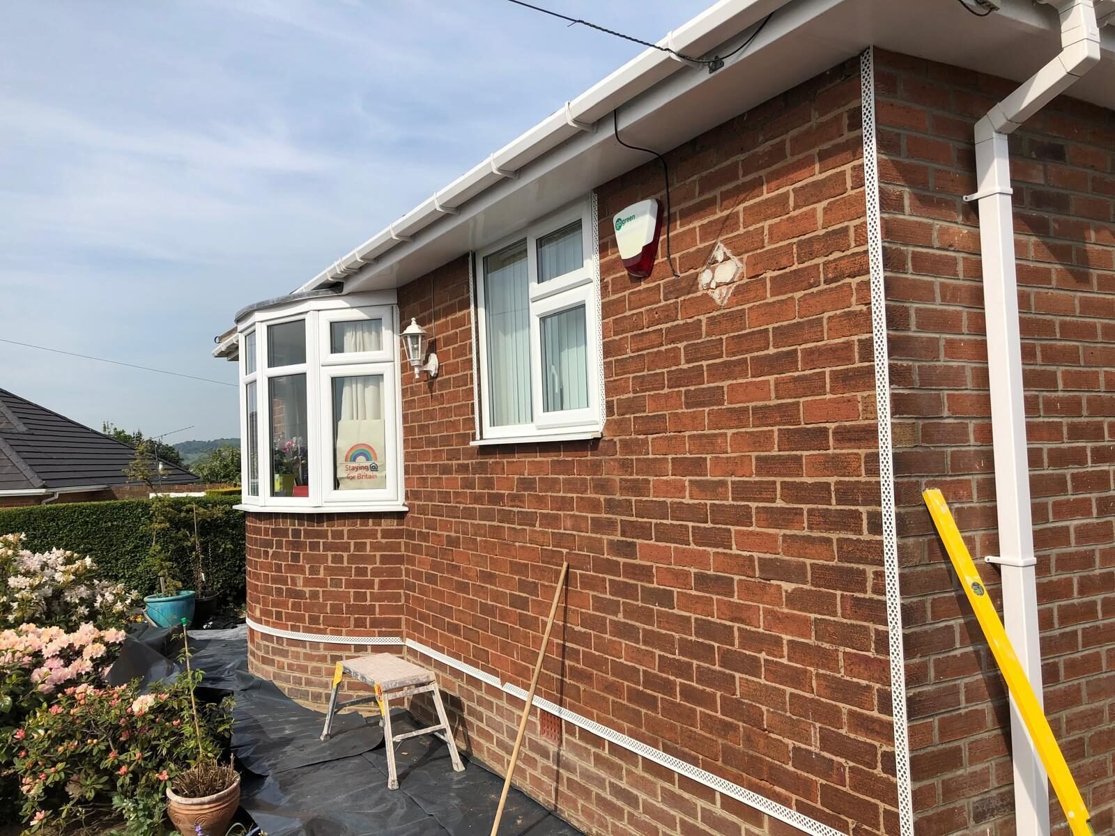 Extension combining red brick and white render